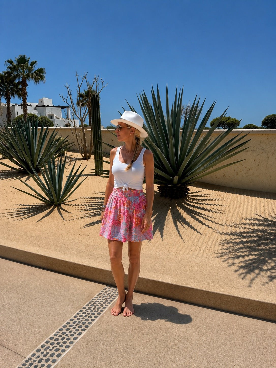 Riviera Mini Skirt back view — vibrant floral print cotton mini with pockets | Sur La Vague
