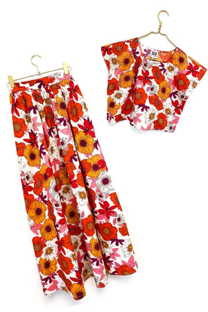 This versatile skirt set with pockets will quickly become your go-to with it's gorgeous bold floral print in vibrant hues.  With multiple ways to wear this set, you can keep it as is or separate the pieces. Pair the top on with jeans and sneakers for a everyday chic look, or thrown on a tank and leather jacket with the skirt for and evening vibe. Breathable, airy design A line top with cap sleeve Flowing Maxi length skirt with pockets Flat Front waistband, elastic back Handmade in India by Sur La Vague